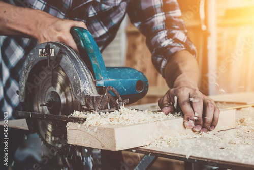 Фотография Carpenter working on wood craft at workshop to produce construction material or wooden furniture