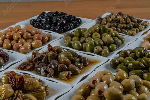 Olives assortment in bowl with oil. 
