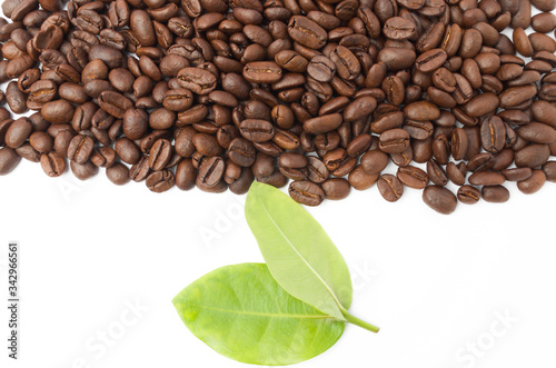 Raw coffee beans with leaf on white background.