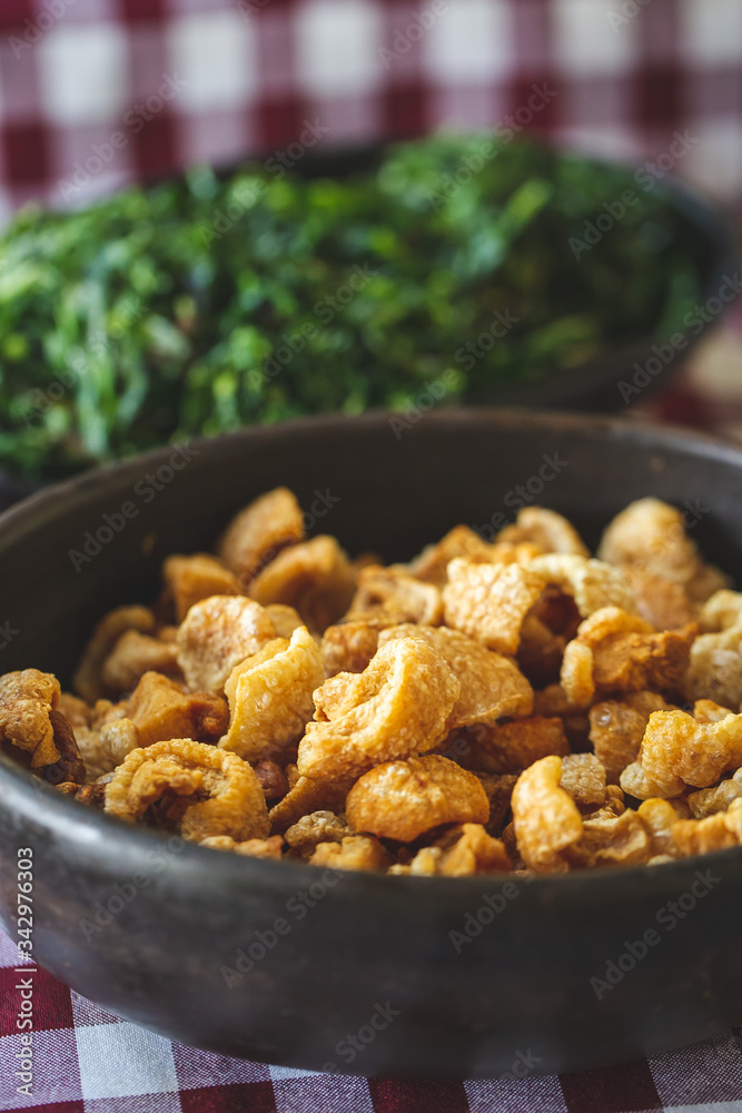 Brazilian pork scratching ( torresmo ) and cabbage ( couve ) Brazilian pork scratching ( torresmo ) and cabbage ( couve )