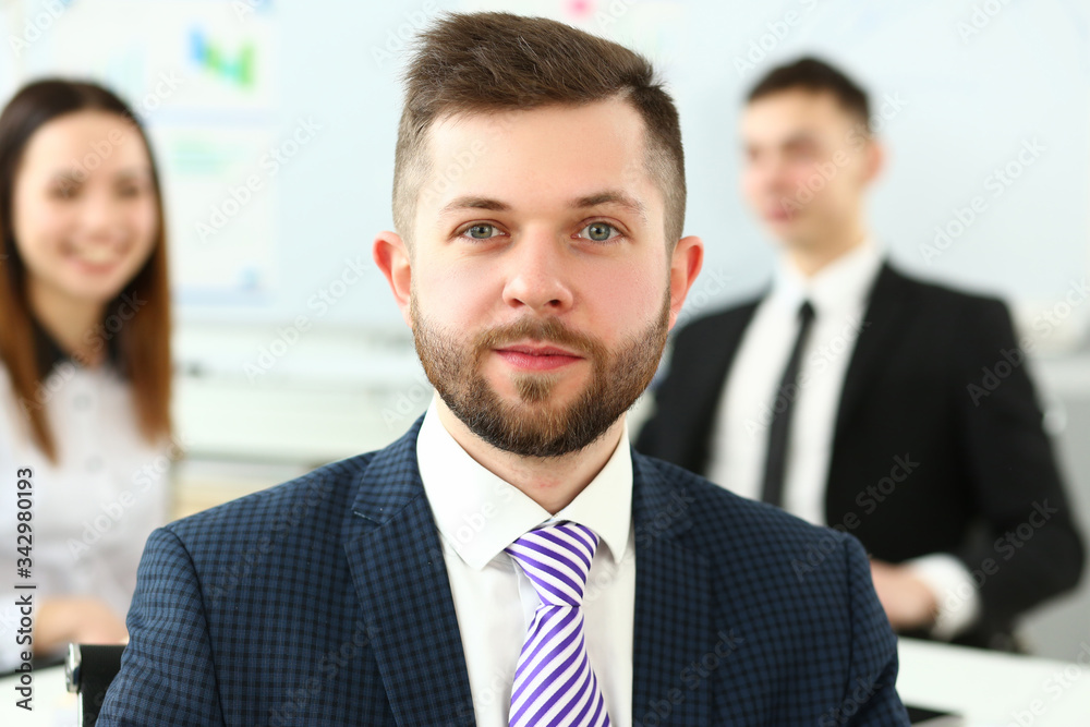 Cheerful clerk worker wearing suit and tie looking in camera in office headshot Cheerful clerk worker wearing suit and tie looking in camera in office headshot