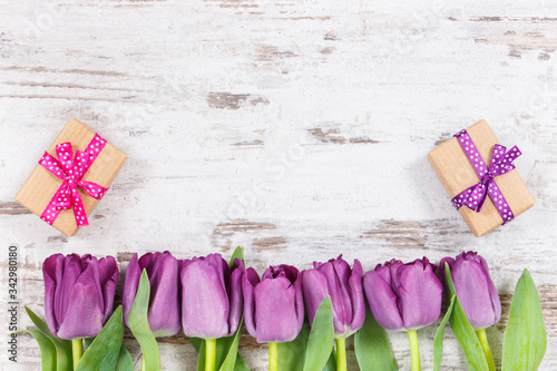 Purple tulips and gifts for different occasions, copy space for text on white boards