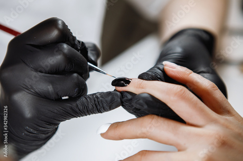 Nail treatment by a manicurist.