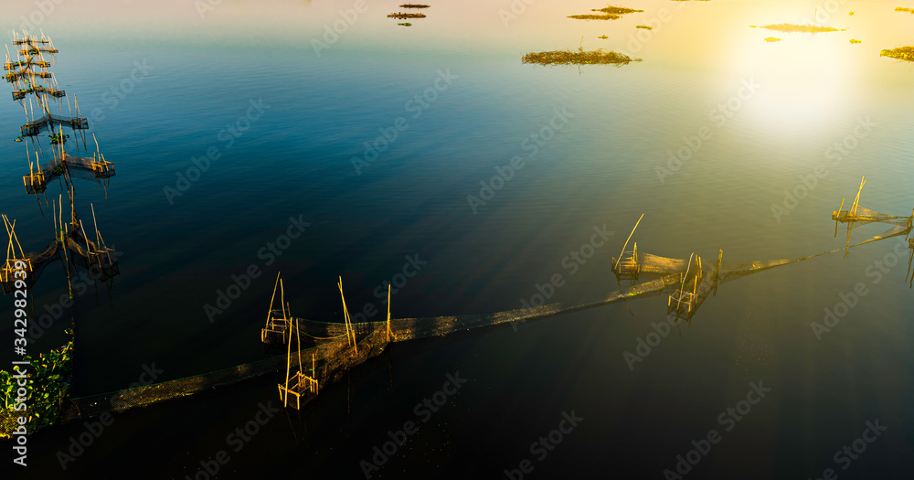 Naklejka premium High angle view of fish farming on a calm river in Myanmar 