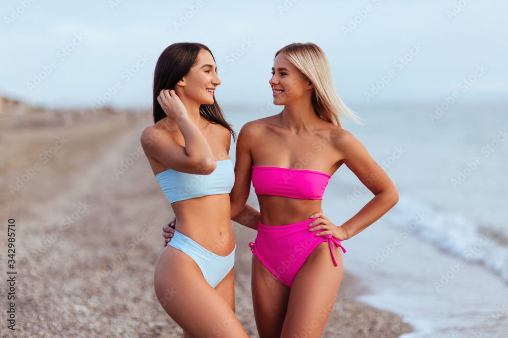 Two amazing tanned girls on the beach