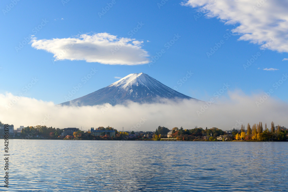 beautiful view of Fuji san mountain with white cloud and blue sky and winter morning fog in autumn season at lake Kawaguchiko, best places in Japan, travel and landscape nature concept