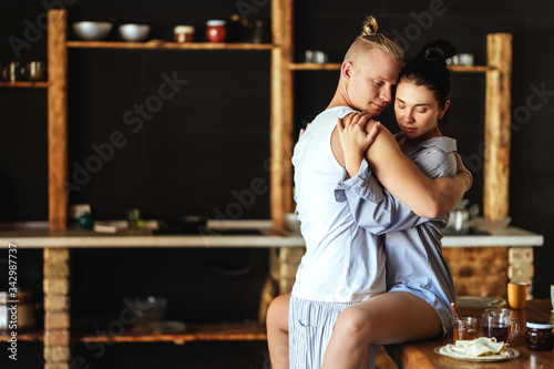 Beautiful young couple cooking in kitchen at home