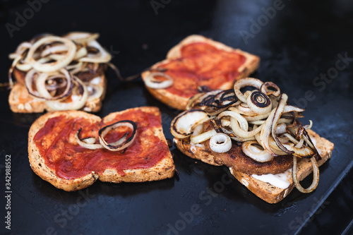 plant-based barbecue, vegan patties on bread with onion and hot sauce on bbq