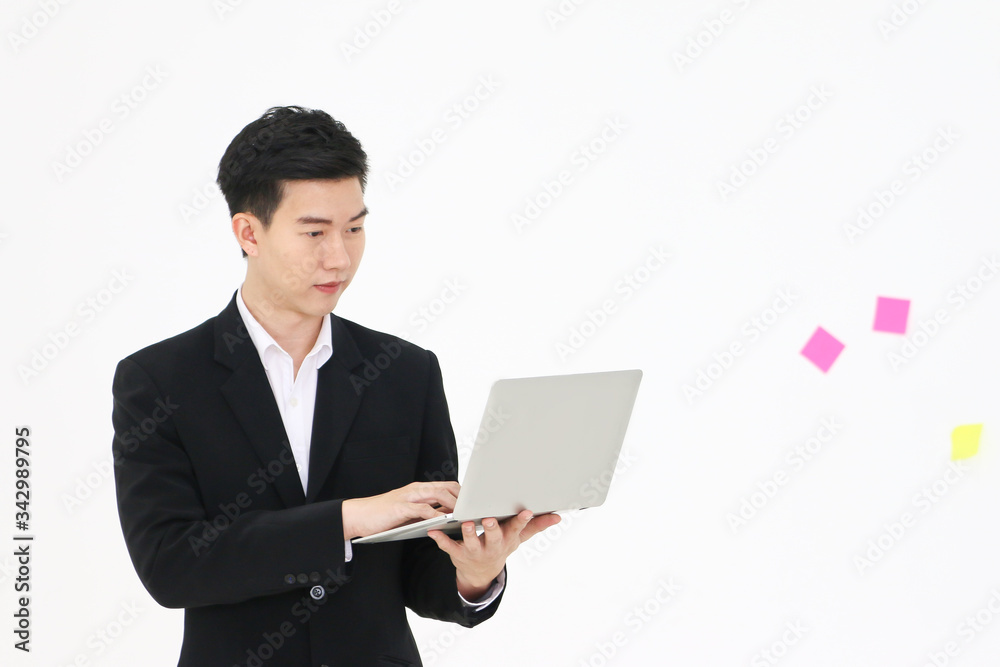 businessman wear suit and smart standing and posing with laptop businessman wear suit and smart standing and posing with laptop