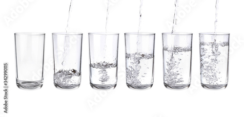 Pouring water into a separate glass on a white background. Clean drinking water concept