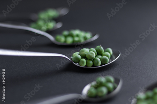 Healthy fresh green peas top view flat lay with black background.