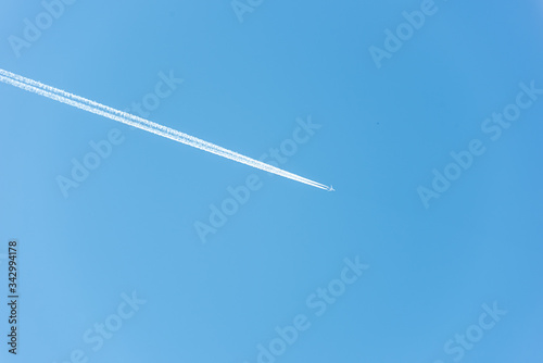 Background with airplane with jet stream in the sky