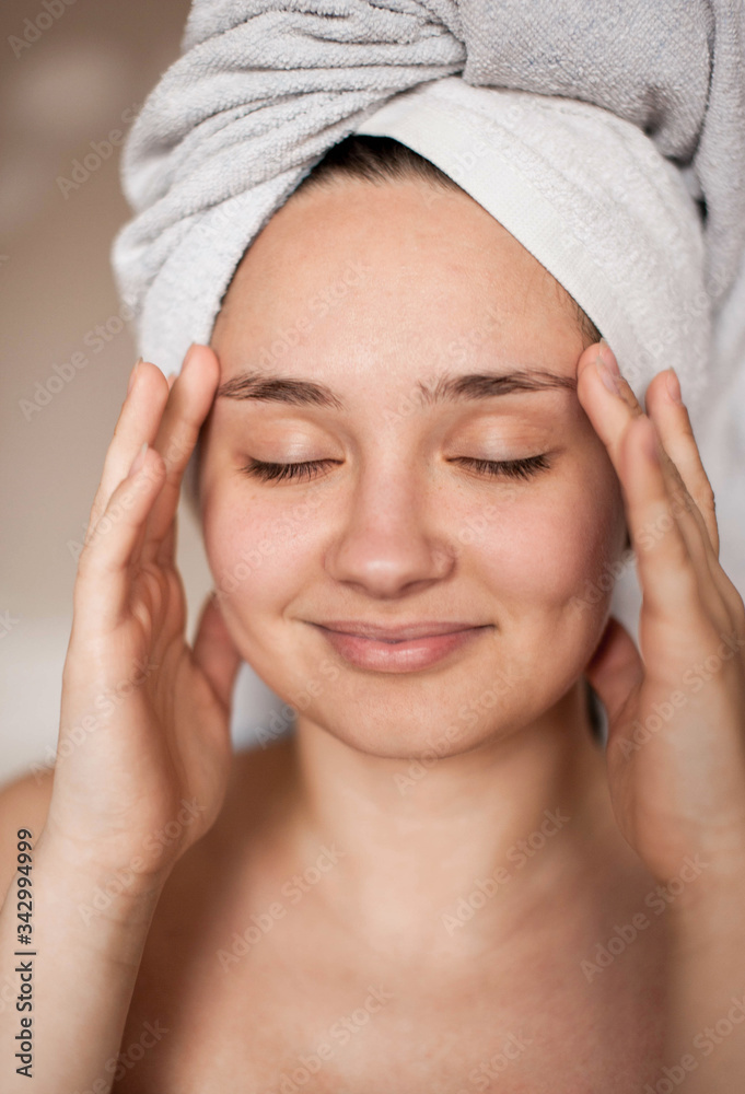 brunette girl without makeup with problem skin naked wrapped in a towel after a bath doing Spa treatments brunette girl without makeup with problem skin naked wrapped in a towel after a bath doing Spa treatments