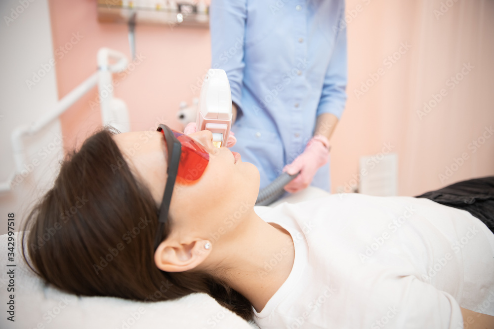 Removal of unwanted hair laser on face mustache young woman. Concept beauty and health Removal of unwanted hair laser on face mustache young woman. Concept beauty and health