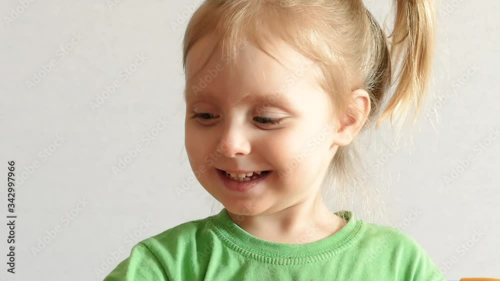 Close up portrait of a happy little child. Beautiful little girl looking at the camera and smiling kindly Close up portrait of a happy little child. Beautiful little girl looking at the camera and smiling kindly
