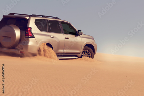 Photography Close up of a golden car stuck in the sand in the Namib desert.