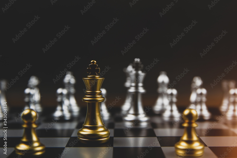 The golden and the silver chess team on the chessboard Concept of business Strategic plan and teamwork management. The golden and the silver chess team on the chessboard Concept of business Strategic plan and teamwork management.
