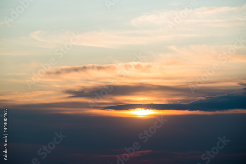 summer fiery red sunset in the mountains against the background of trees