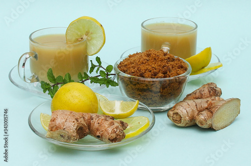 Ginger juice with lemon and brown sugar in a cup and saucer