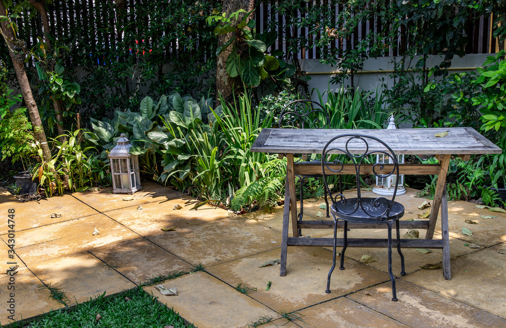 Old wooden table and black steel chair for outdoor gardens.