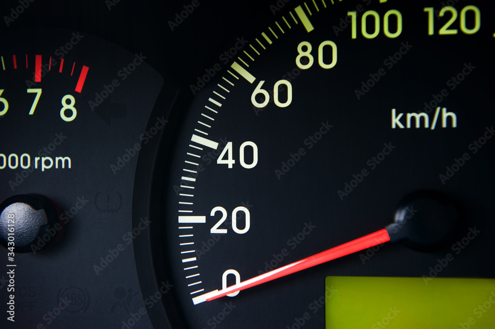 Close-Up of a Glowing black car Speedometer with a red arrow indicating 0 Close-Up of a Glowing black car Speedometer with a red arrow indicating 0