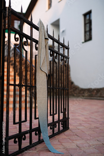 knitted scarf hanging on a forged fence