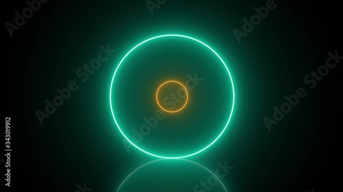 Neon circles with changing colors and reflections on the floor - abstract movement in a seamless loop