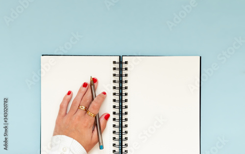 Girl hand in a notebook, ready to learning and accomplish objectives and education goals