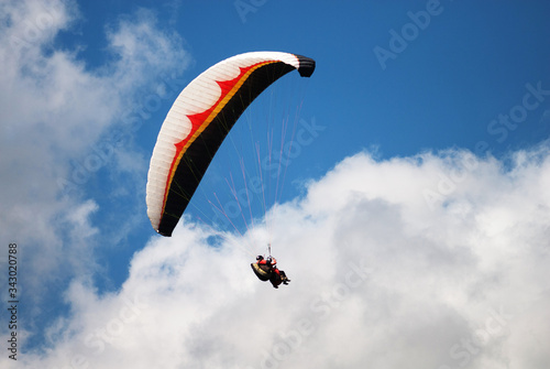 Wallpaper Mural Paraglider Flying in a Blue Sky with clouds Torontodigital.ca