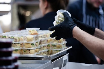 scenes from commercial kitchen preparing food for take away and delivery