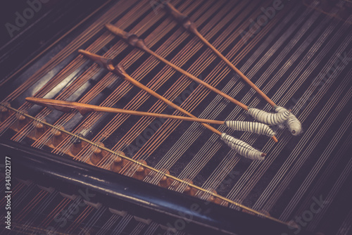 Antique violin and violin bow lying on dulcimer. Close up a violin instrument and cymbal photo