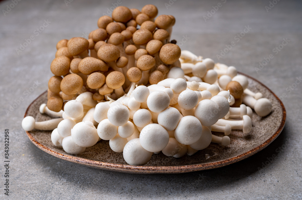 Fresh buna brown and bunapi white shimeji edible mushrooms from Asia, rich in umami tasting compounds such as guanylic and glutamic acid