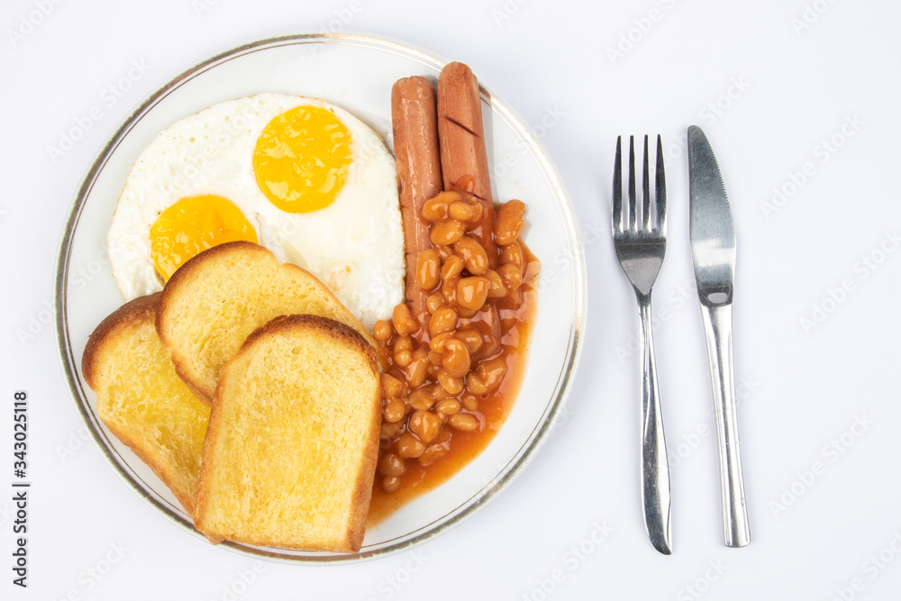 English breakfast with fried eggs, sausages, beans and toasts on white background.