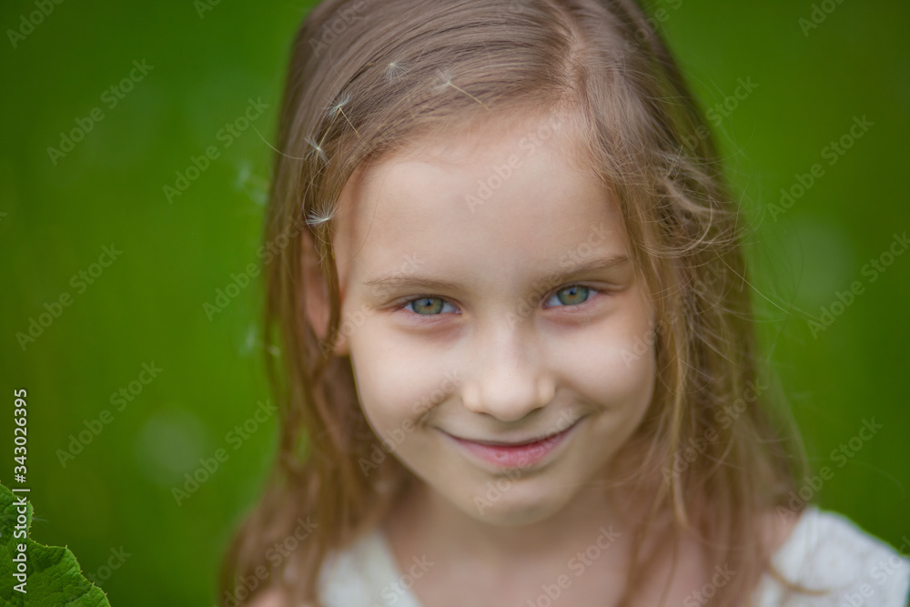 large portrait of a beautiful little girl with a dandelion large portrait of a beautiful little girl with a dandelion
