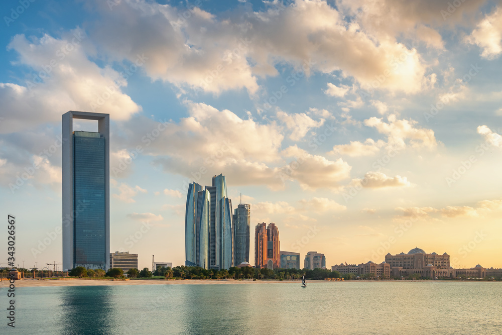 Cityscape of Abu Dhabi with modern skyscrapers at sunset, UAE