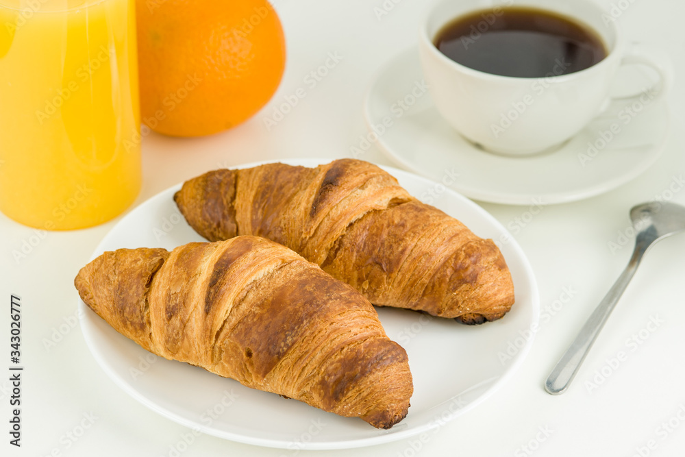 Cup of coffee, juice, orange and two croissants, Breakfast