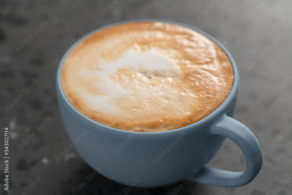 Fresh cappuccino in blue cup on concrete background Fresh cappuccino in blue cup on concrete background