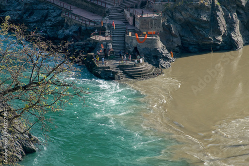 Confluence of muddy colored Alakananda and green colored Bhagirathi river to form Ganges at Devprayag, Uttarakhand, India. This point is known as Sangam & people offers prayers at temple built here.