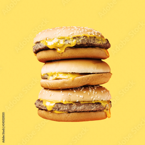 Gamburgers on the yellow color. Fast food concept.