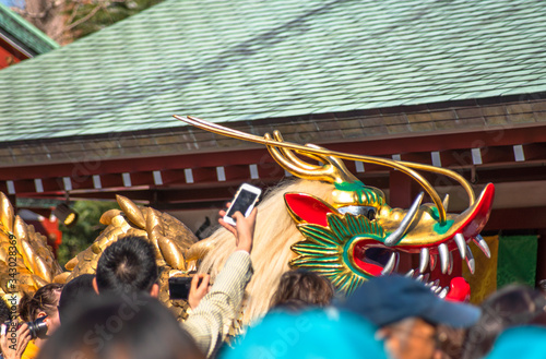 Crowd taking with a smartphone or a camera a huge golden dragon dancing during the festival dedicated to the bodhisattva Kannon in the Sensoji temple of Asakusa. photo