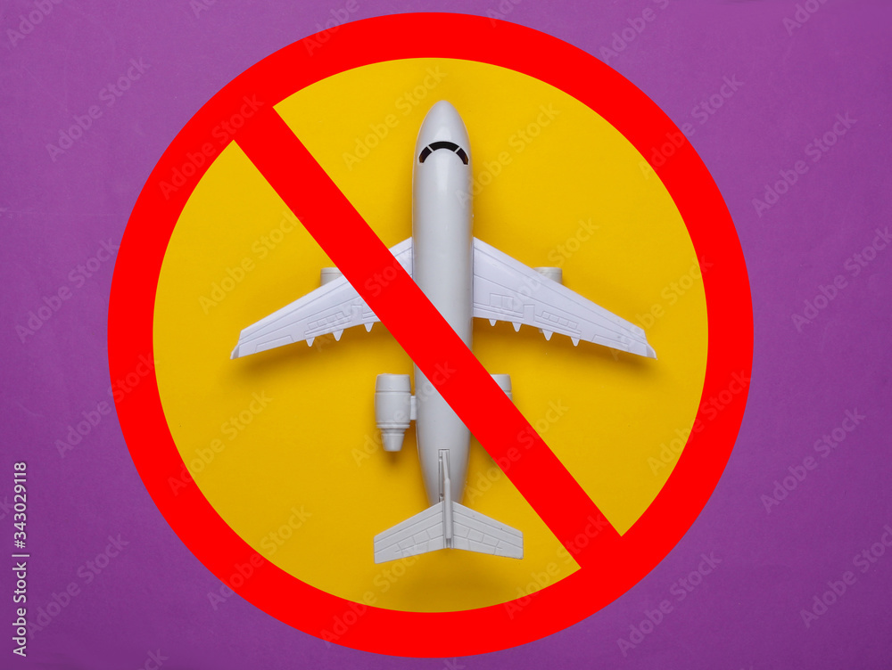 The prohibition of air travel. Passenger airplane model with a prohibition sign The prohibition of air travel. Passenger airplane model with a prohibition sign