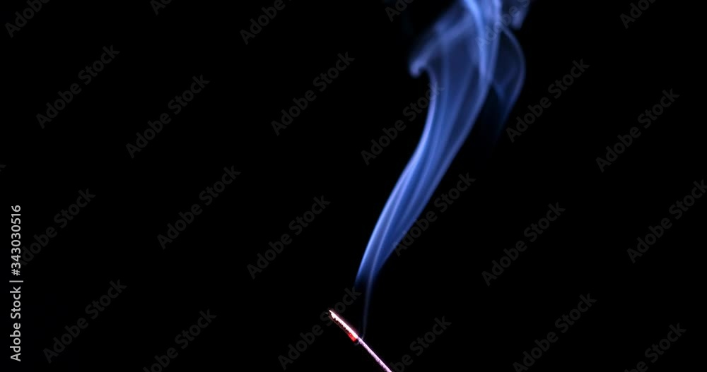 Incense stick with smoke isolated on black background Incense stick with smoke isolated on black background