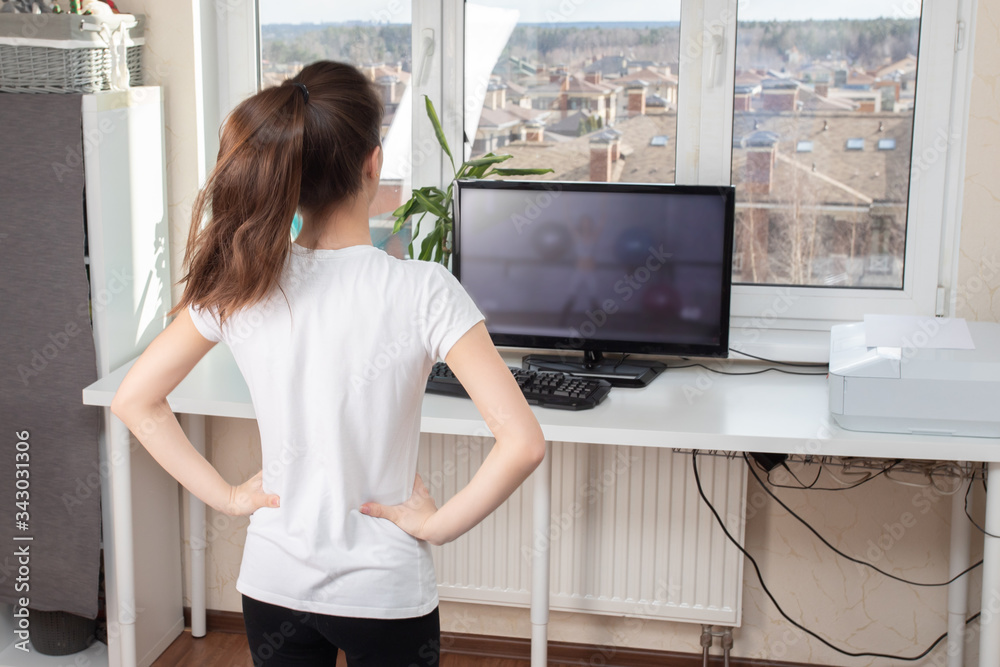 Beauty and health at home. Going for sports through the Internet. Young woman doing exercises Beauty and health at home. Going for sports through the Internet. Young woman doing exercises