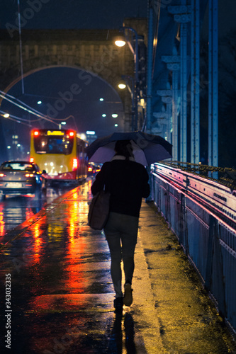 Women walking with the umbrella during rain in the city.