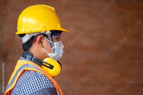 Engineer wear protective face masks safety for Coronavirus Disease 2019 (COVID-19) at construction site,Health and Construction Concept.
