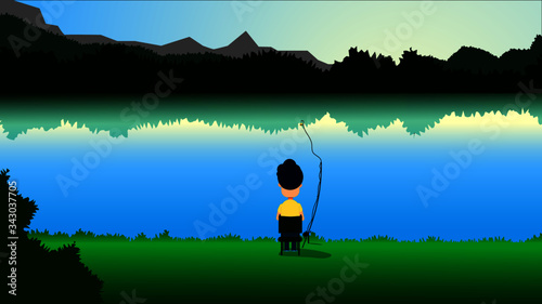 Fisherman sits on the shore of a mountain lake