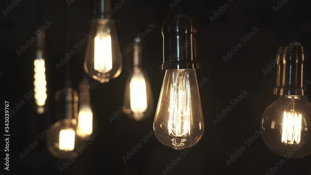 Turning light ON and OFF. Decorative antique edison style light bulbs hanging from the ceiling.