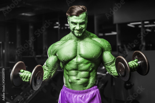 Bodybuilder strong man pumping up biceps muscles © antondotsenko