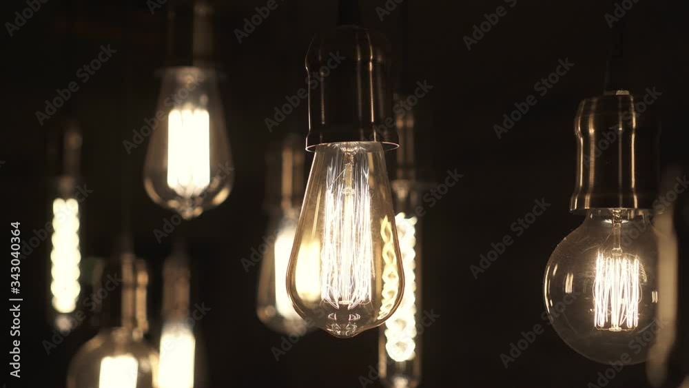 Turning light ON and OFF. Decorative antique edison style light bulbs hanging from the ceiling.