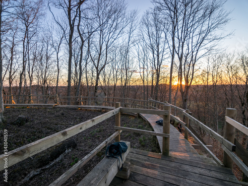 landscape with large trees, pedestrian wooden footbridges and view from above, beautiful sunset colors in spring photo